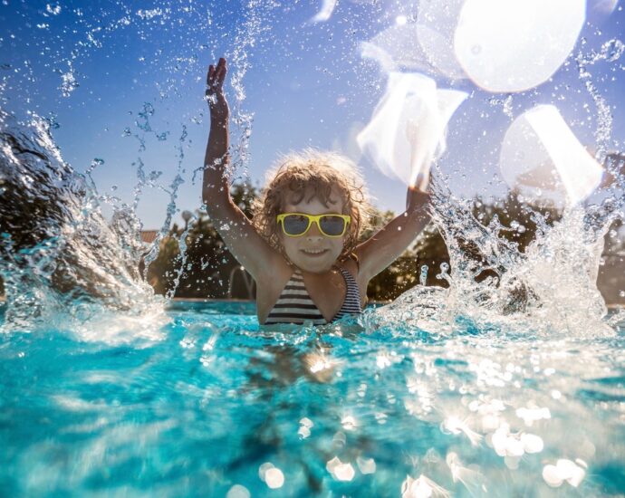 Child splashing in pool