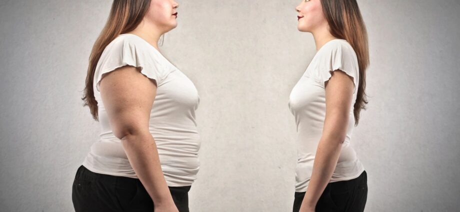woman looking at herself before and after significant weight loss