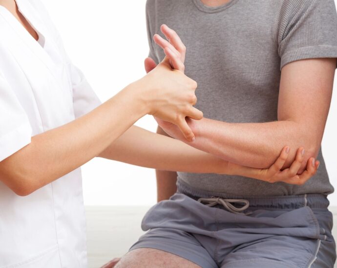 doctor examining a person's wrist