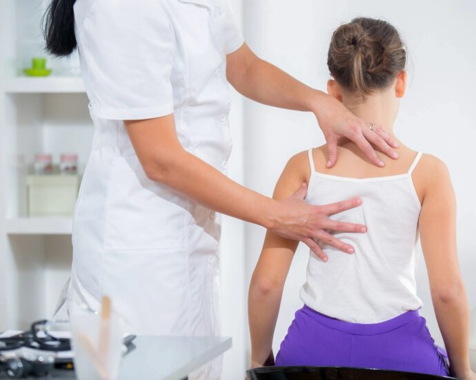 Chiropractor adjusting a girl's back